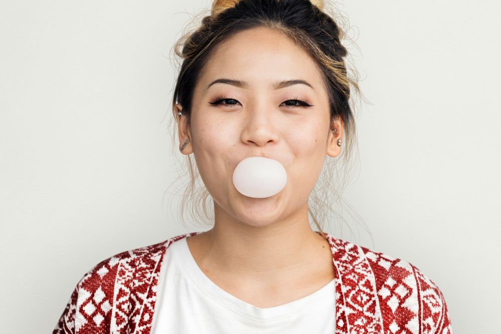Woman Blowing a bubble with gum