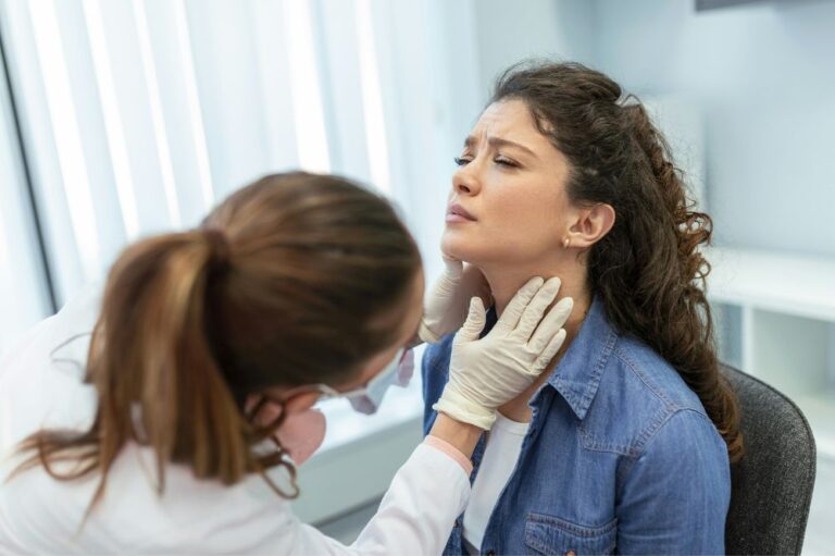 Woman getting her tonsils checked.