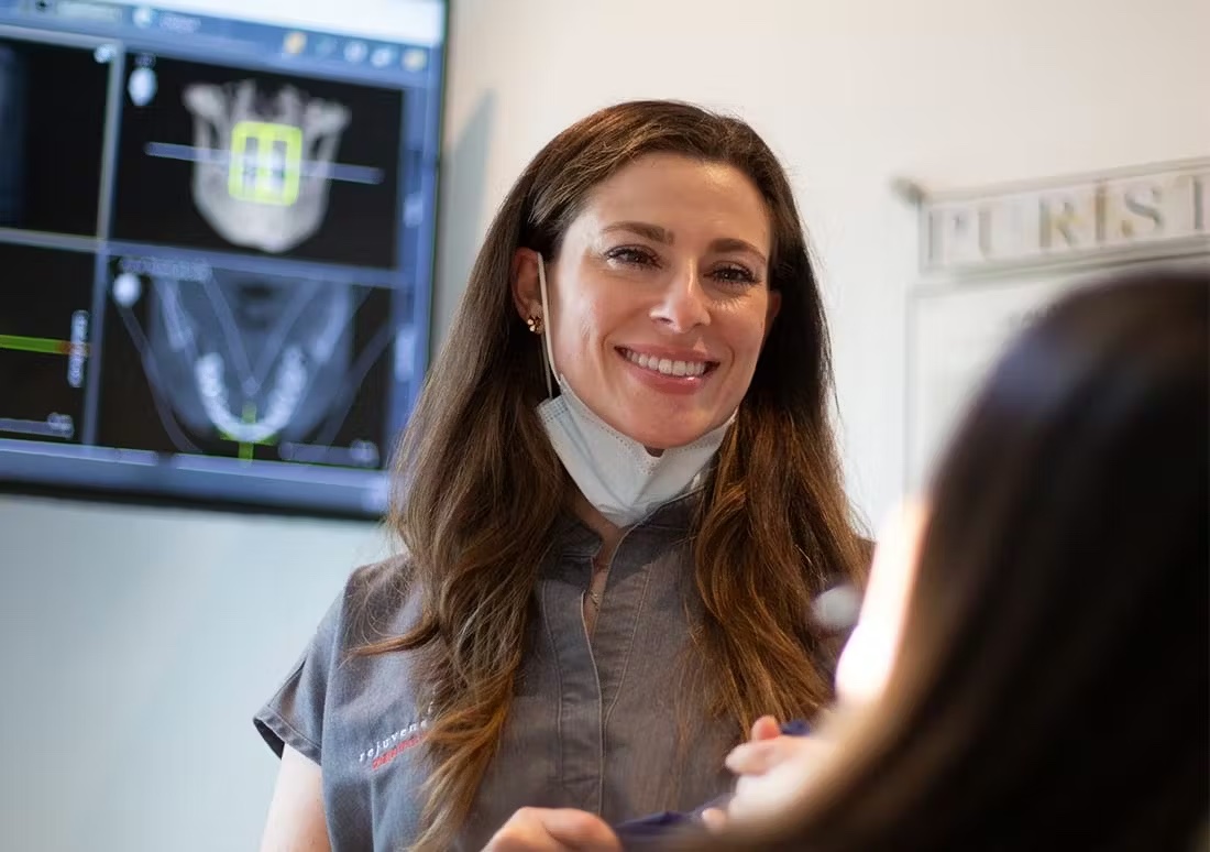 A dentist talking to a patient