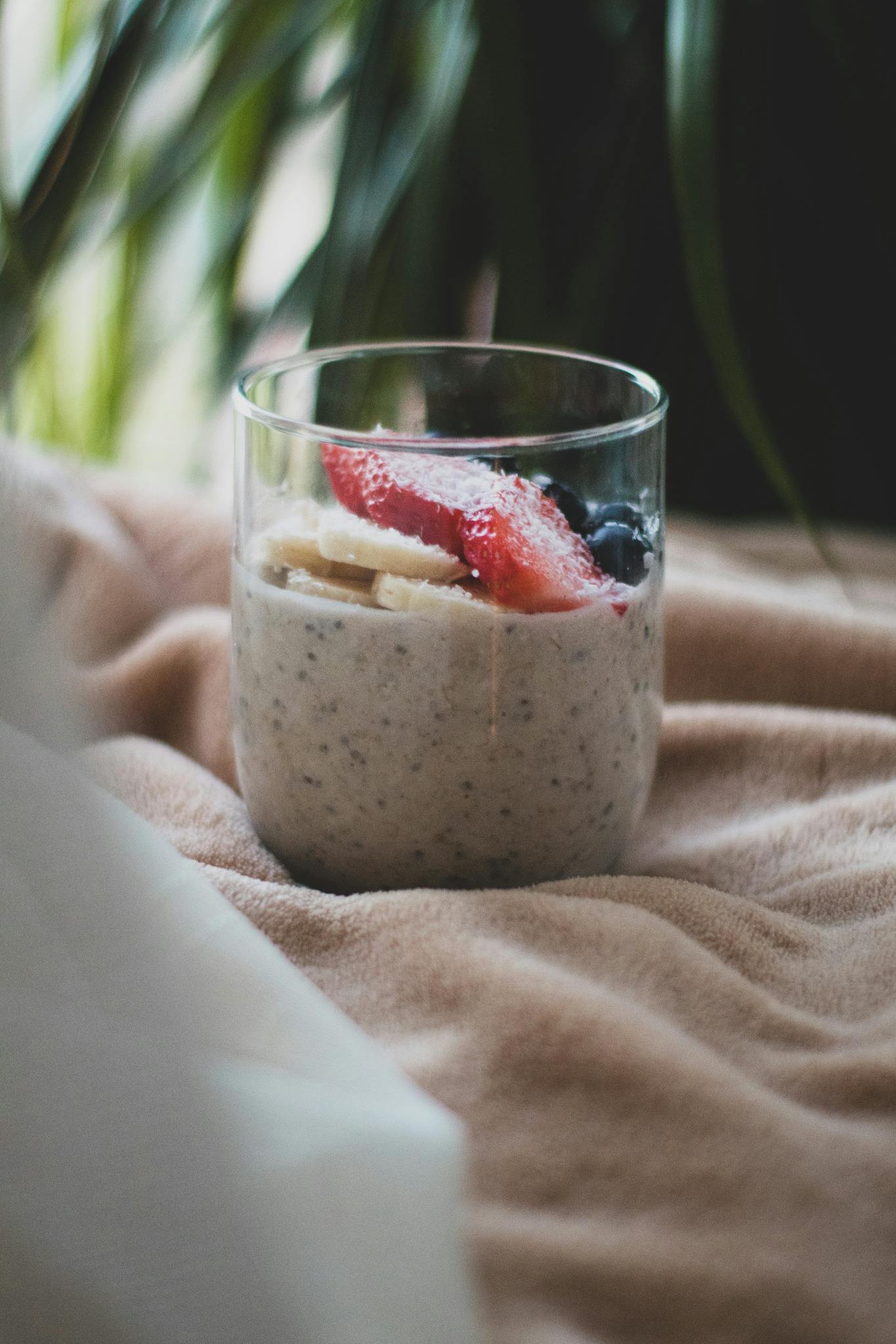 A delicious and healthy smoothie with strawberries, bananas, and blueberries served in a glass.
