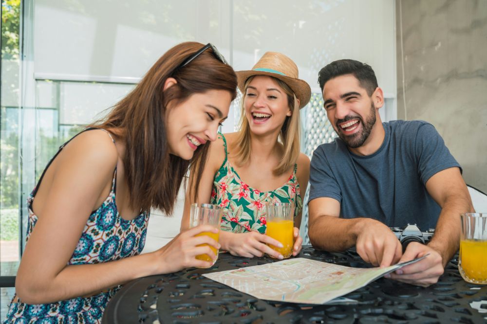 2 women and 1 man laughing